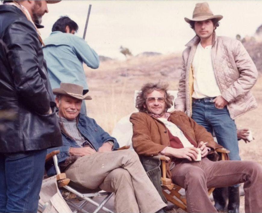 Backstage in cowboy hats, camp chairs, and a break before the next take.